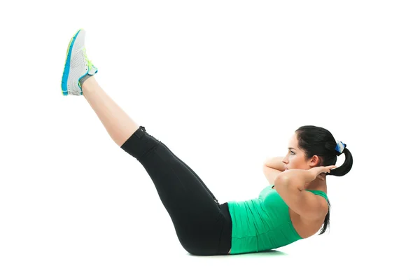 Beautiful sporty woman doing exercise on the floor — Stock Photo, Image