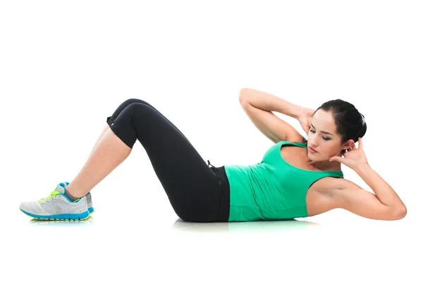 Bela mulher esportiva fazendo exercício no chão — Fotografia de Stock