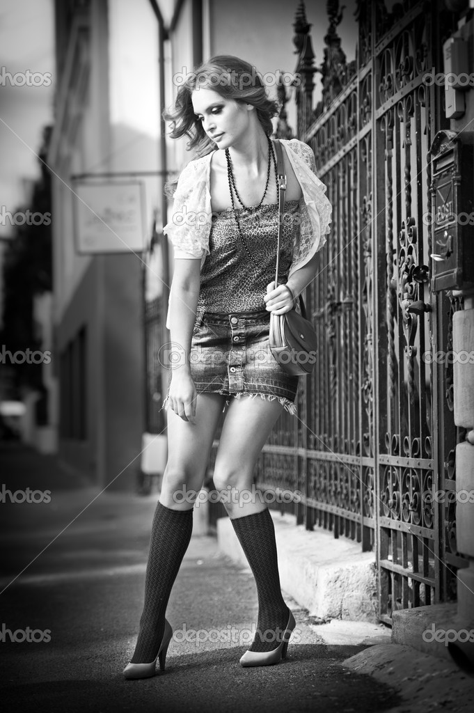 Girl short skirt and bag walking on street.Young European Girl in Urban ...
