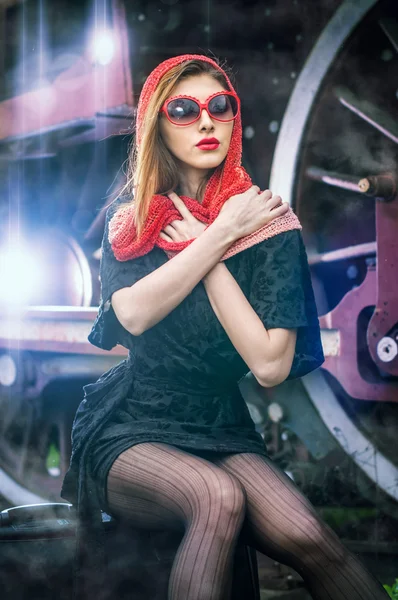 Sexy chica atractiva a la espera de aterrizar en la plataforma en el tren de la vendimia. Mujer vintage en estilo de los años veinte esperando el tren. Mujer de estilo retro con maleta en la plataforma a la espera de tren — Foto de Stock