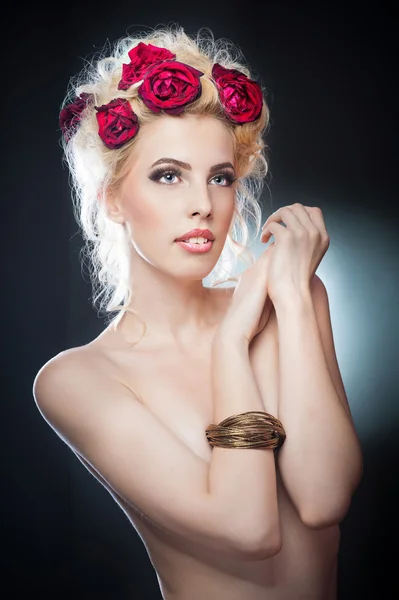 Peinado hermoso retrato de arte femenino sexy con rosas. Elegancia. Novia rubia natural genuina con flores rojas. Artista.Retrato de una hermosa mujer rubia con flores en el pelo. Foto de moda —  Fotos de Stock