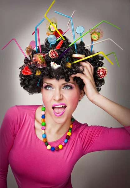 Portrait of a beautiful female model on white background with lollipops in the hair — Stock Photo, Image