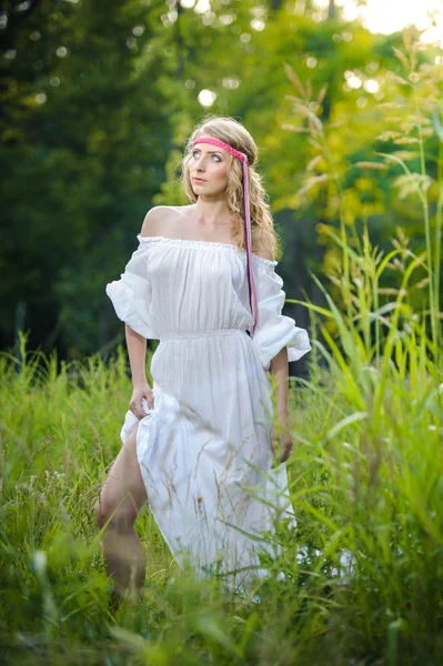 Retrato de uma jovem mulher loira sensual em campo em vestido longo branco sexy. Retrato de bela menina loira ao ar livre. Mulher bonita desfrutando de campo verde, menina bonita relaxante ao ar livre — Fotografia de Stock