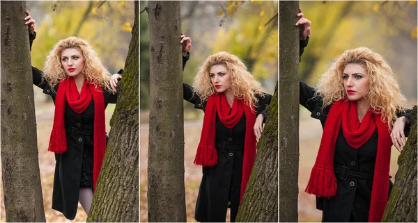 Jovem atraente em uma sessão de moda de outono. Menina bonita e elegante com cachecol vermelho no parque. Mulheres loiras com acessórios vermelhos posando ao ar livre. Menina cabelo bonito agradável entre duas árvores — Fotografia de Stock