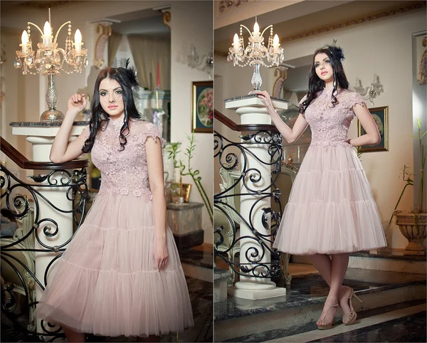 Beautiful long hair girl in nude colored dress posing in a vintage scene. Young beautiful woman wearing a lace dress in luxury scenery on stairs. Sensual elegant young woman in nude dress indoor shot. — Stock Photo, Image