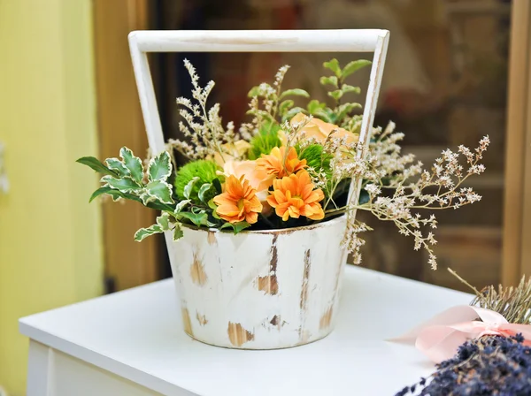 Arrangement de fleurs en pot vintage blanc. Décoration de mariage avec des fleurs jaunes. Arrangement gerberas jaunes sur table blanche . — Photo