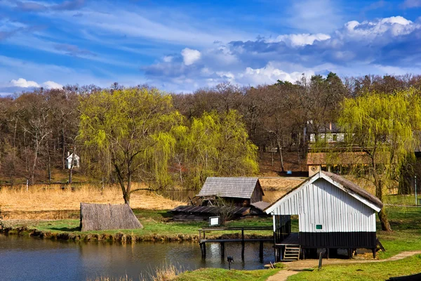 Landscape with pile buildings near lake — Stock Photo, Image