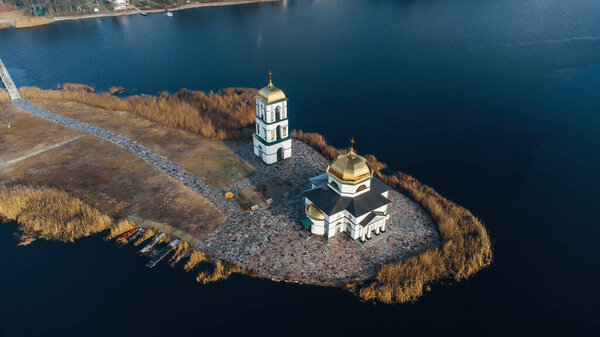 Aerial view of the old Church of the Transfiguration with a bell tower on the island of the Kanev reservoir, the flooded village of Gusintsy, Rzhishchev, Ukraine.