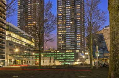 Rotterdam, The Netherlands, January 6, 2022: downtown Willemsplein square, surrounded by offices, residential towers and parking garages, in the blue hour before sunrise