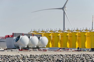 Rotterdam, The Netherlands, August 23, 2022: large parts of future offshore wind turbines waiting for shipping towards the North Sea on Maasvlakte industrial area