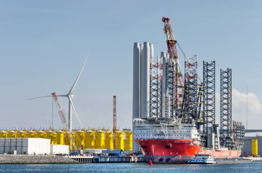 Rotterdam, The Netherlands, August 23, 2022: construction vessel and storage area for wind turbine parts on Maasvlakte industrial area