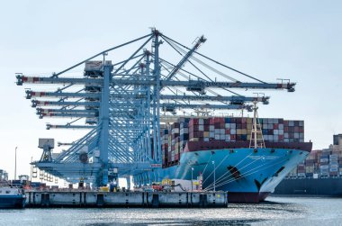 Rotterdam, The Netherlands, August 23, 2022: large cranes and vessels at one of the container terminals on Maasvlakte industrial area