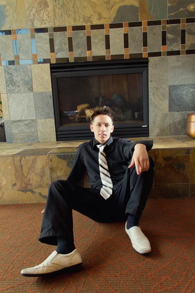 Male Model Wearing Formal Suit and Tie Sitting on Floor