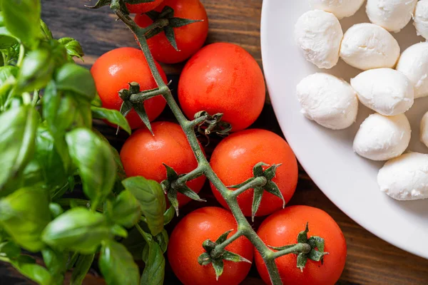 Świeże Dojrzałe Liście Bazylii Aromatycznymi Pomidorami Włoską Mozzarellą Stole Obok — Zdjęcie stockowe