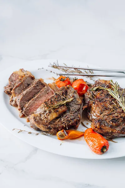 Juicy Well Fried Ribeye Steaks White Platter White Marble Surface Royalty Free Stock Images