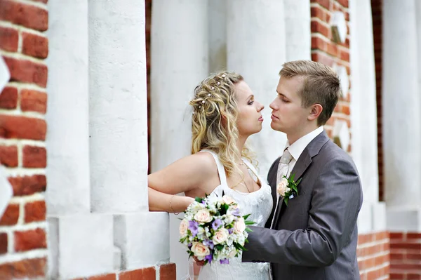 Happy bride and groom near palace — Stock Photo, Image