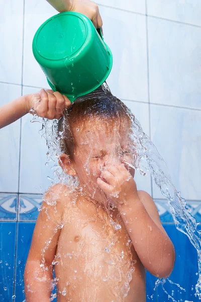 Baby in bathroom pouring water — Stock Photo, Image
