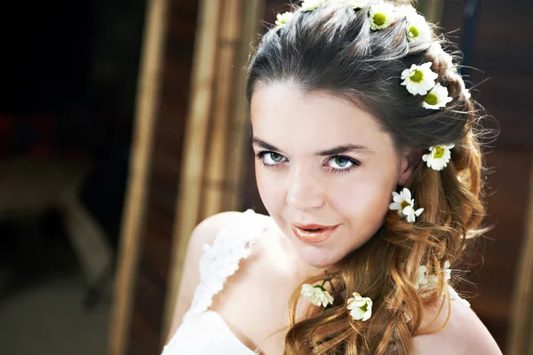 Beautiful bride with flowers in hair — Stock Photo, Image