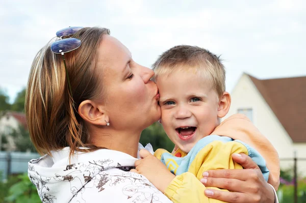 Happy mother kissing baby — Stock Photo, Image