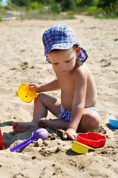 Lapsi leikkii hiekassa — kuvapankkivalokuva