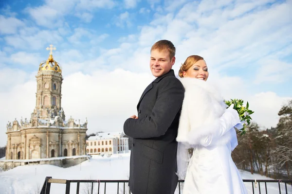 Happy bride and groom near ancient temple — Stock Photo, Image