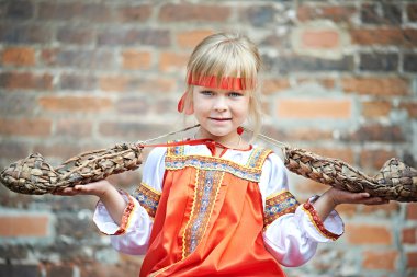 Little girl in national costumes with bast clipart