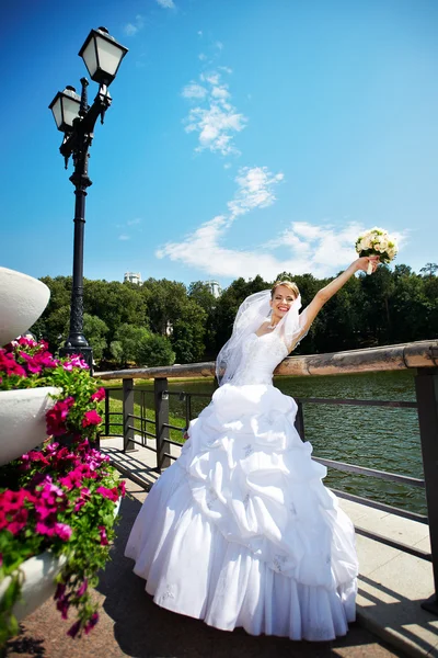 Happy beautiful bride in park — Stock Photo, Image