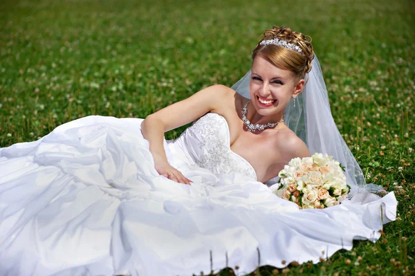 Happy bride on grass — Stock Photo, Image