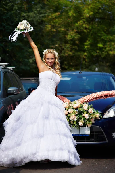 Щаслива наречена з букетом біля весільного авто — стокове фото