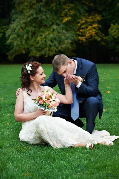 Elegant groom kisses hand of his beautiful bride — Stock Photo, Image