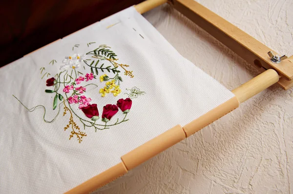 Wooden frame and fabric with embroidery — Stock Photo, Image