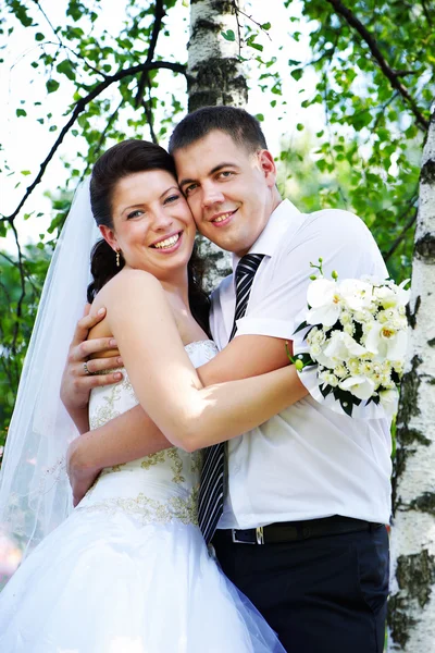 Happy bride and groom at the birches — Stock Photo, Image