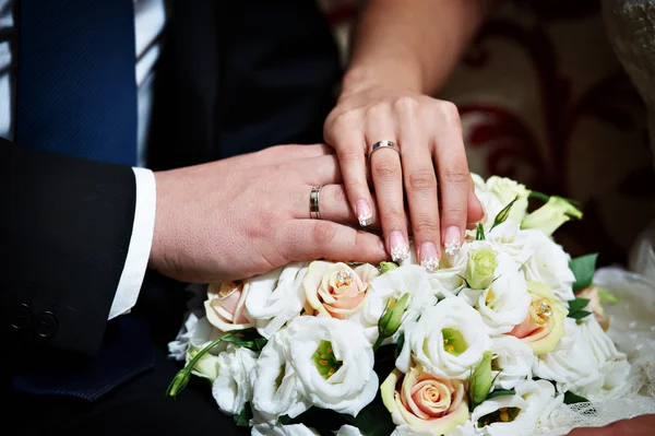 Mãos com anéis de ouro do casamento feliz recém-casados — Fotografia de Stock