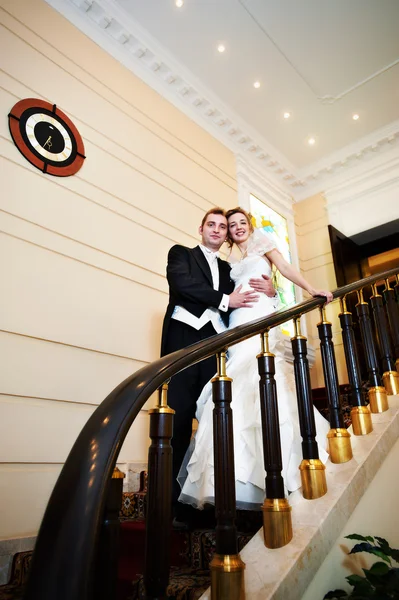 Happy bride and groom at luxurious stairs — Stock Photo, Image