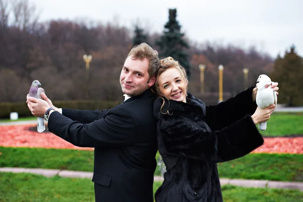 Bride and groom with pigeons on hands — Stock Photo, Image