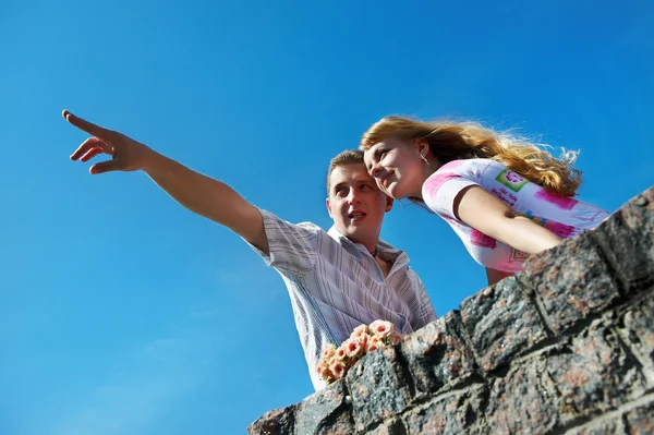 Young man show his girlfriend that in the distance Stock Image