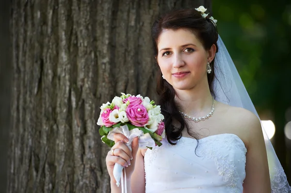 Happy bride with bouquet — Stock Photo, Image