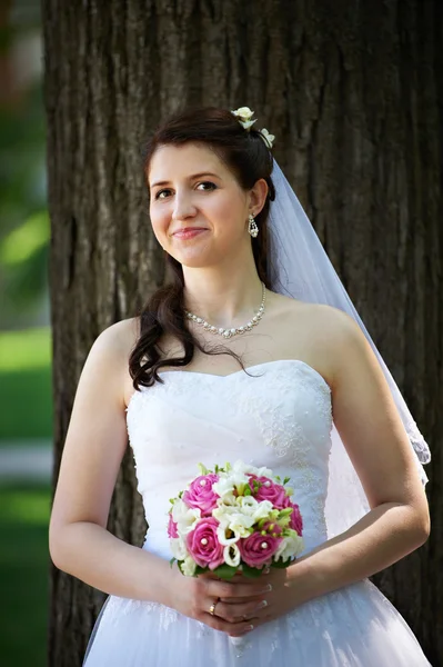Happy bride with bouquet in wedding walk Royalty Free Stock Images