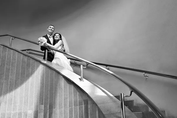 Happy bride and groom on ladder — Stock Photo, Image