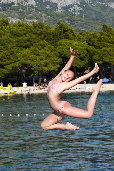 Girl jumping in the sea — Stock Photo, Image