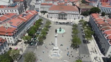 Lisbon, Portugal - July 1, 2022: A drone camera flies around over the Dom Pedro IV Square (Rossio Square)
