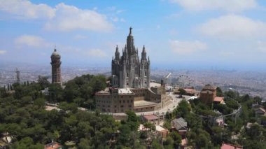 A camera drone ascends above the Temple of the Sacred Heart of Jesus and Tower of the Waters of Two Rivers