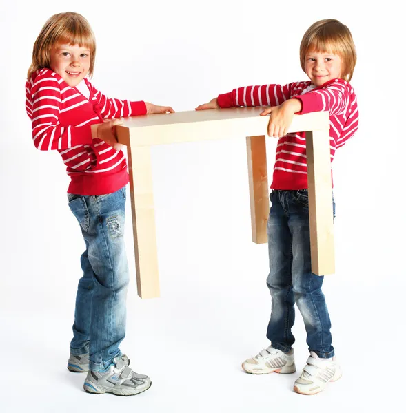 Sisters lift a table