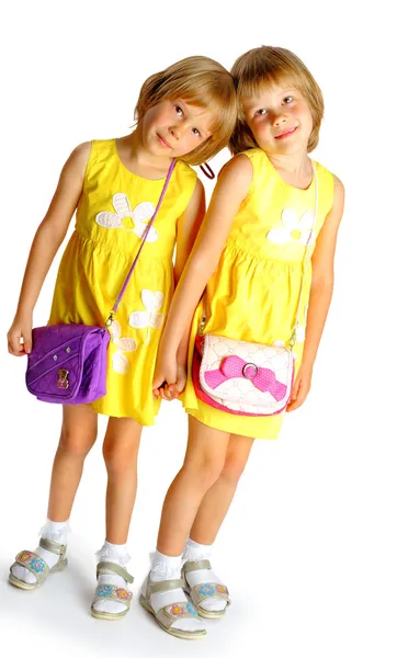 Sisters twins in yellow dresses — Stock Photo, Image