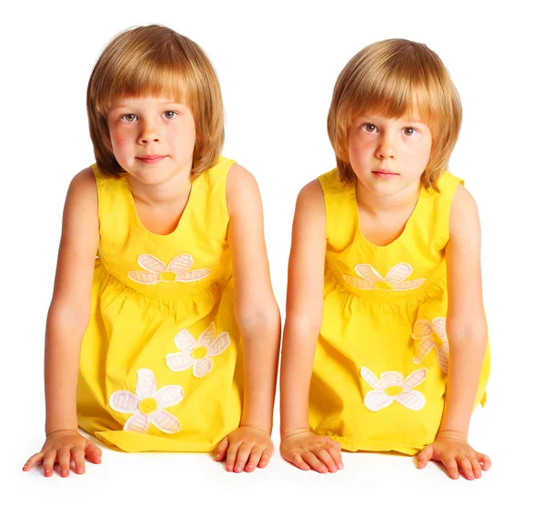 Sisters twins in yellow dresses — Stock Photo, Image