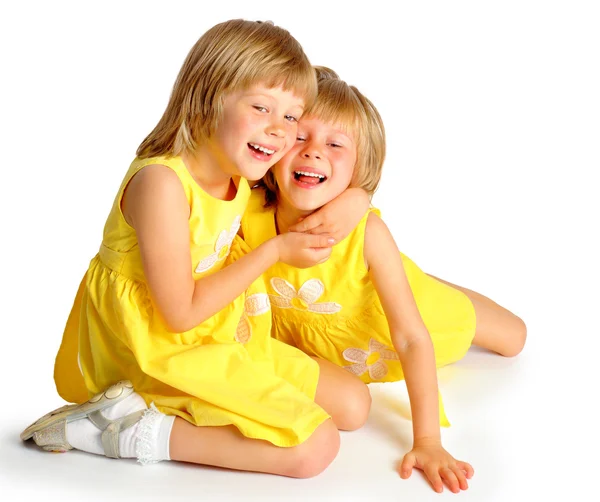 Sisters twins in yellow dresses — Stock Photo, Image