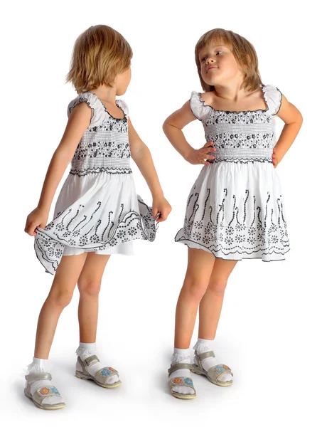 Sisters twins in white dresses play — Stock Photo, Image