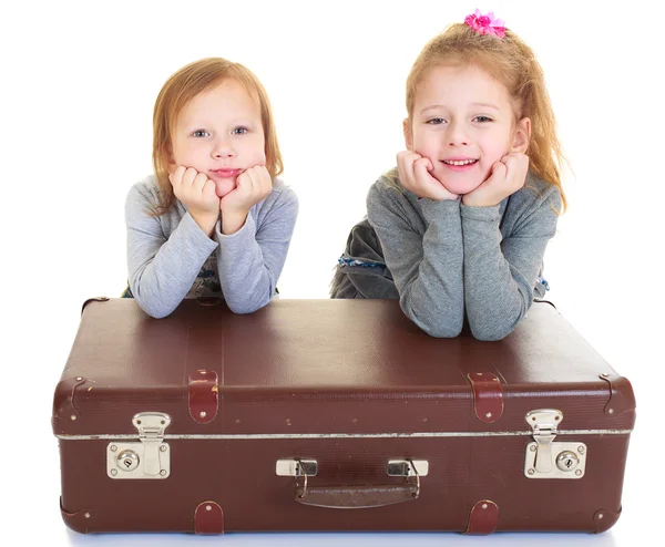 Girls sisters with an old suitcase — Stock Photo, Image