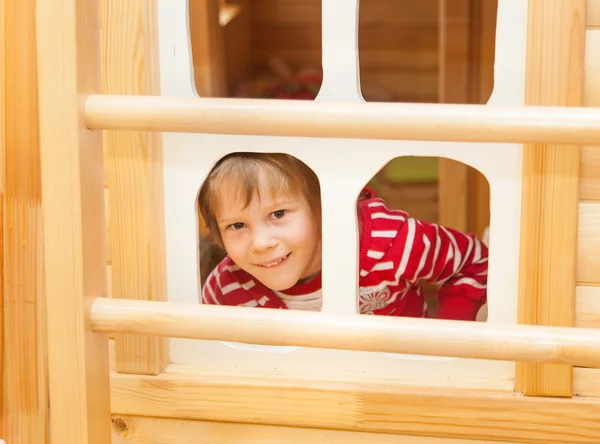 Little girl peaks out the window — Stock Photo, Image