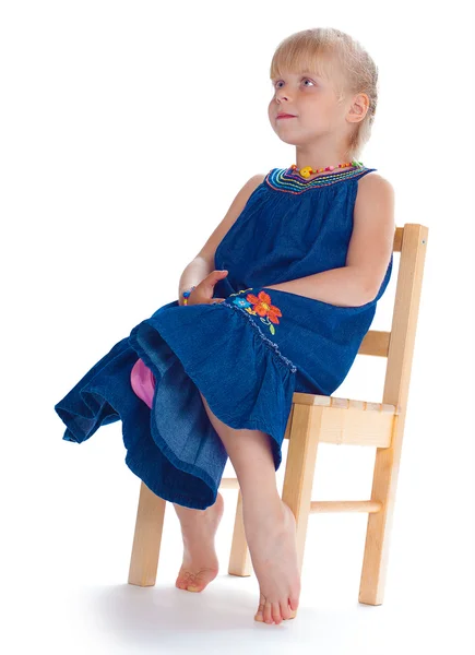 The girl sits on a chair — Stock Photo, Image